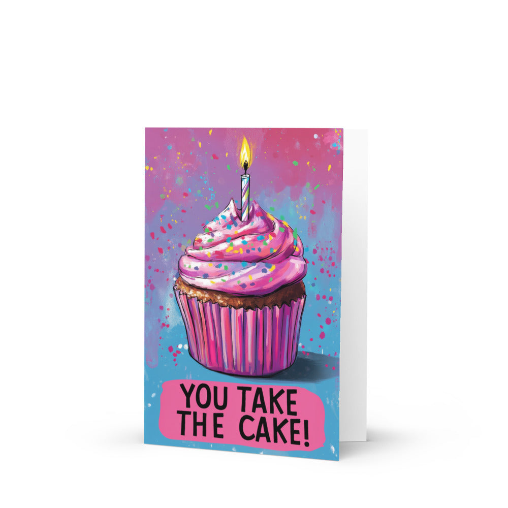 A vibrant pink birthday cupcake card featuring colorful sprinkles and a lit candle, with the phrase 'YOU TAKE THE CAKE!' prominently displayed in bold letters, perfect for celebrating special occasions.