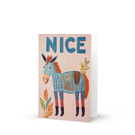 Whimsical embroidered donkey greeting card with 'NICE ASS' text, vibrant colors on pink background, perfect for humorous occasions and unique gifts.