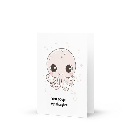 Charming watercolor illustration of a cute baby octopus with expressive eyes, set against a clean white background, featuring the playful text 'You ocupi my thoughts' in pale pink font, perfect for greeting card lovers.