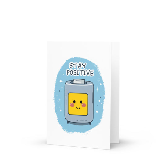 Stay Positive Battery Greeting Card featuring a kawaii smiling battery illustration on a light blue background, perfect for spreading joy and uplifting messages for all occasions.