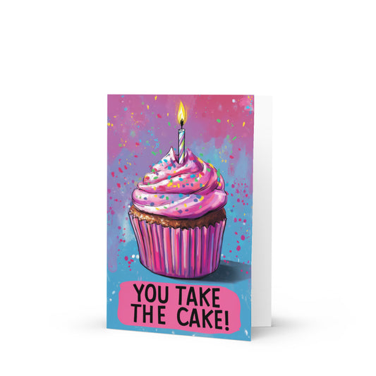 A vibrant pink birthday cupcake card featuring colorful sprinkles and a lit candle, with the phrase 'YOU TAKE THE CAKE!' prominently displayed in bold letters, perfect for celebrating special occasions.