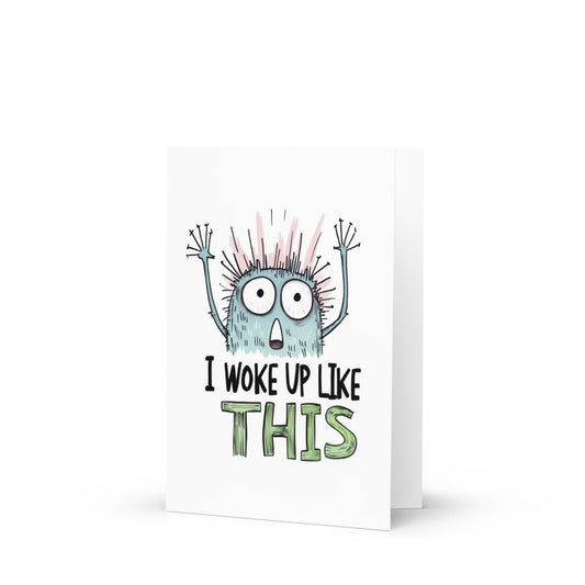 Whimsical greeting card featuring an adorable monster with the phrase 'I WOKE UP LIKE THIS' on a vibrant white background, perfect for spreading smiles and laughter.