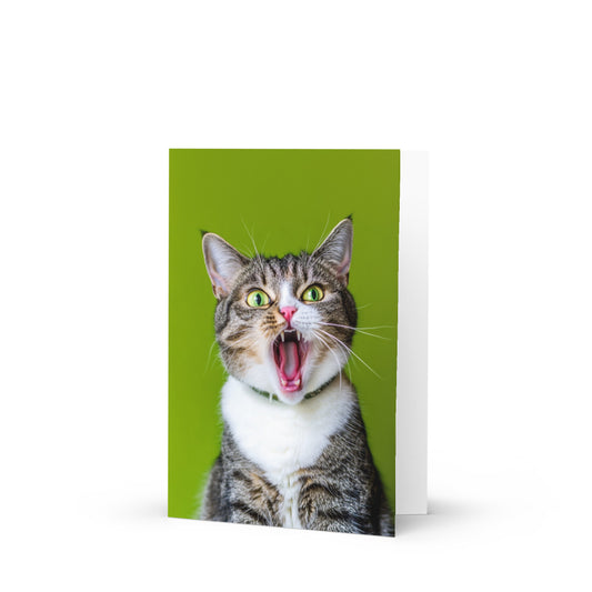 Surprised cat birthday card with vibrant green background, featuring funny text 'LESBIANS EAT WHAT?!' perfect for quirky birthday celebrations and gifts.