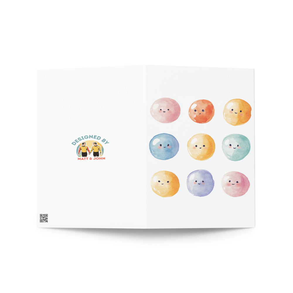 Whimsical greeting card showcasing nine smiling embryos in a grid, ideal for IVF celebrations, made with eco-friendly materials for a heartfelt gift.